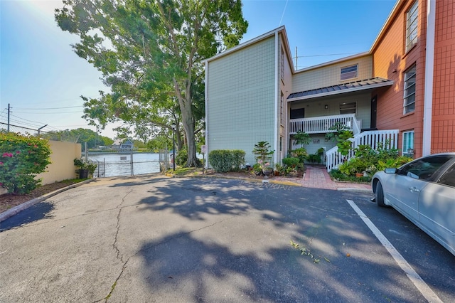2424 W Tampa Bay Blvd Unit I202, Tampa, FL 33607 - view of side of property featuring a gate and uncovered parking