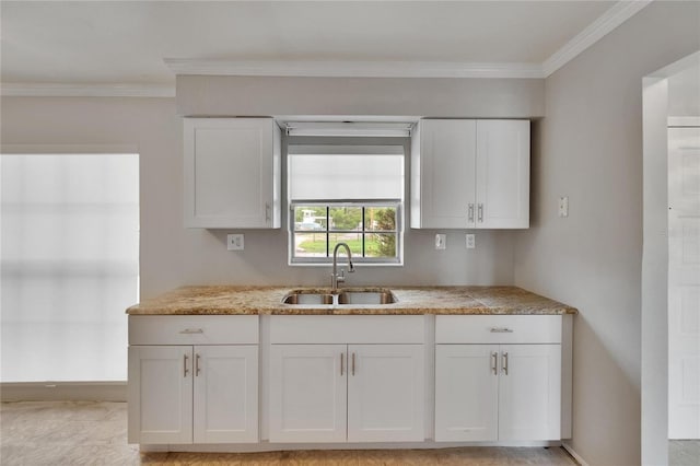 814 Seabreeze Dr, Ruskin, FL 33570 - kitchen with a sink, white cabinetry, crown molding, and baseboards