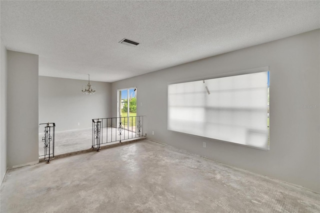 814 Seabreeze Dr, Ruskin, FL 33570 - empty room featuring a chandelier, a textured ceiling, and concrete floors