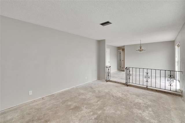814 Seabreeze Dr, Ruskin, FL 33570 - spare room with a chandelier, a textured ceiling, and carpet