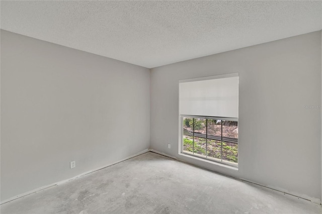 814 Seabreeze Dr, Ruskin, FL 33570 - empty room with concrete flooring and a textured ceiling