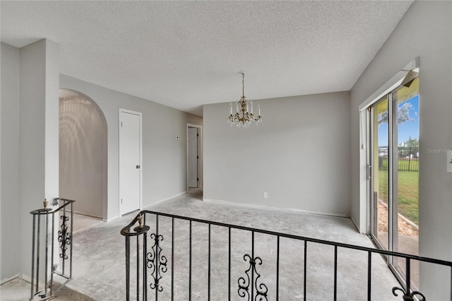 814 Seabreeze Dr, Ruskin, FL 33570 - unfurnished dining area featuring plenty of natural light, a textured ceiling, a chandelier, arched walkways, and light colored carpet