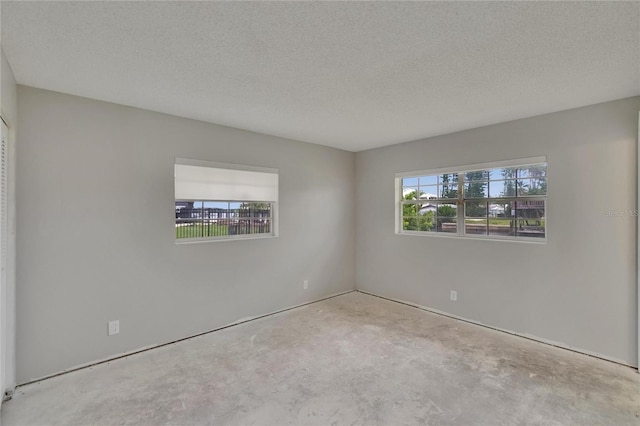 814 Seabreeze Dr, Ruskin, FL 33570 - empty room with unfinished concrete floors and a textured ceiling