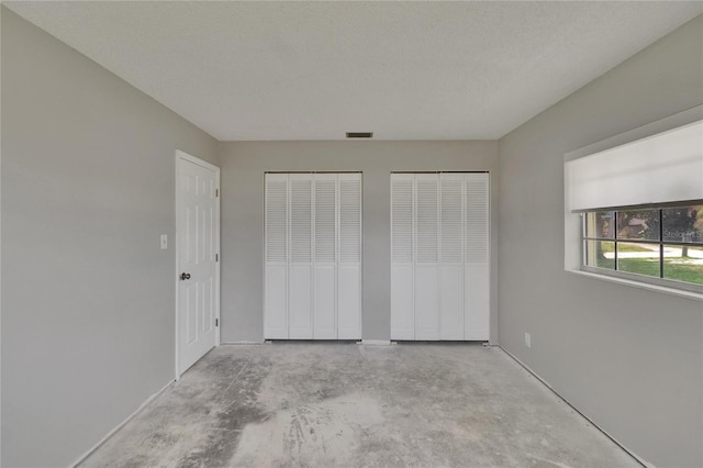 814 Seabreeze Dr, Ruskin, FL 33570 - unfurnished bedroom with two closets and unfinished concrete flooring