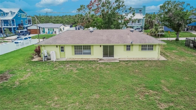 814 Seabreeze Dr, Ruskin, FL 33570 - back of property featuring roof with shingles, stucco siding, and a residential view