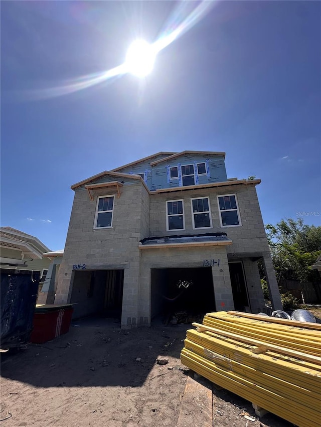 unfinished property featuring an attached garage