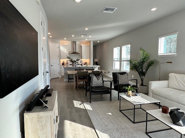 living room with wood finished floors and recessed lighting