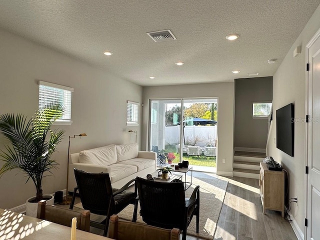 1311 S Moody Ave Unit 1, Tampa, FL 33629 - living area featuring light wood-style floors, recessed lighting, a textured ceiling, and plenty of natural light