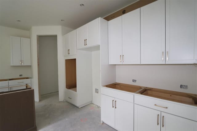 1311 S Moody Ave Unit 1, Tampa, FL 33629 - kitchen featuring unfinished concrete flooring and white cabinetry