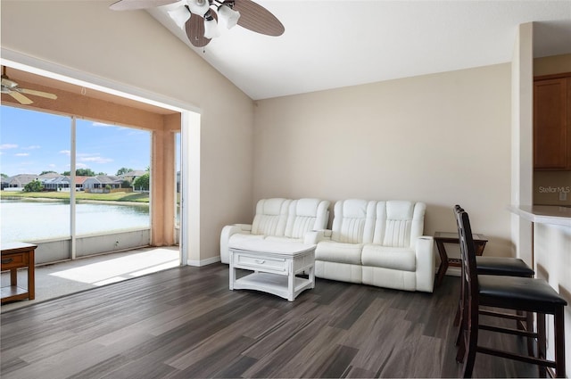 living room with a ceiling fan, vaulted ceiling, dark wood-style floors, and a water view