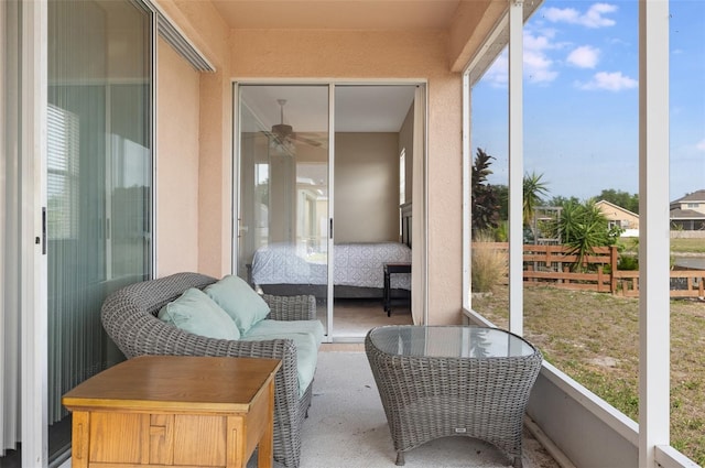 sunroom featuring ceiling fan