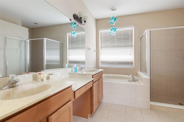 bathroom featuring a stall shower, tile patterned floors, a garden tub, and vanity
