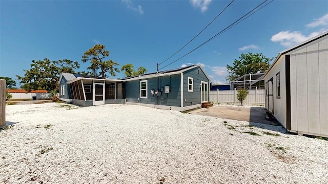 1402 Freemont St S, Gulfport, FL 33707 - rear view of house with a sunroom, fence, and a patio