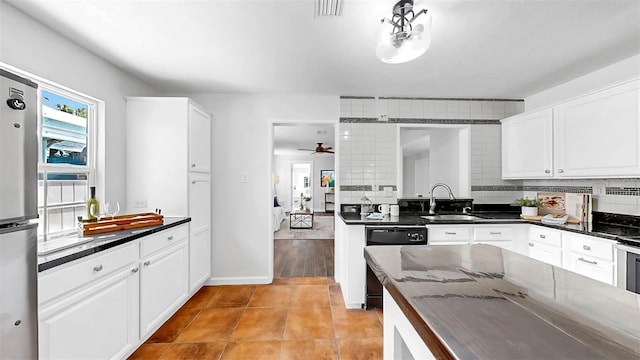 1402 Freemont St S, Gulfport, FL 33707 - kitchen with a sink, freestanding refrigerator, a ceiling fan, and white cabinets