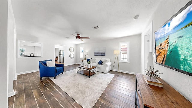 1402 Freemont St S, Gulfport, FL 33707 - living room with ceiling fan, baseboards, and dark wood-style floors