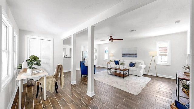 1402 Freemont St S, Gulfport, FL 33707 - living area featuring healthy amount of natural light, ceiling fan, and baseboards