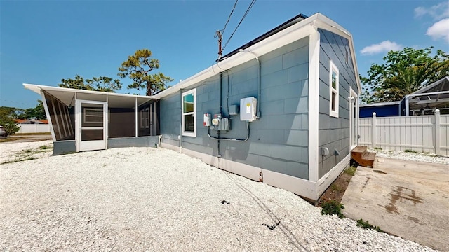 1402 Freemont St S, Gulfport, FL 33707 - rear view of property with a sunroom and fence