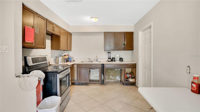 995 Merrimac St, Deltona, FL 32725 - kitchen with stainless steel electric stove, light tile patterned floors, a sink, and light countertops