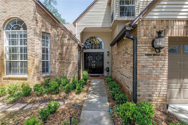 13785 Oak Forest Blvd S, Seminole, FL 33776 - entrance to property with an attached garage and brick siding
