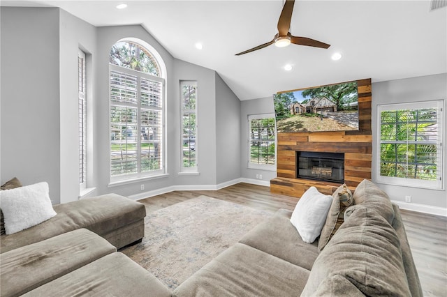 13785 Oak Forest Blvd S, Seminole, FL 33776 - living area with baseboards, plenty of natural light, vaulted ceiling, and wood finished floors