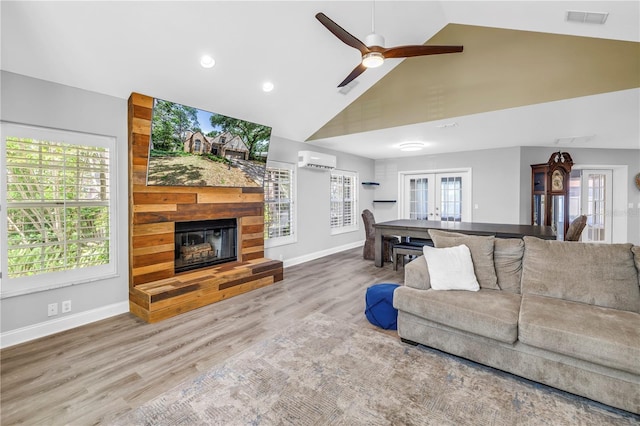 13785 Oak Forest Blvd S, Seminole, FL 33776 - living room with a fireplace, a wall mounted air conditioner, high vaulted ceiling, a ceiling fan, and visible vents