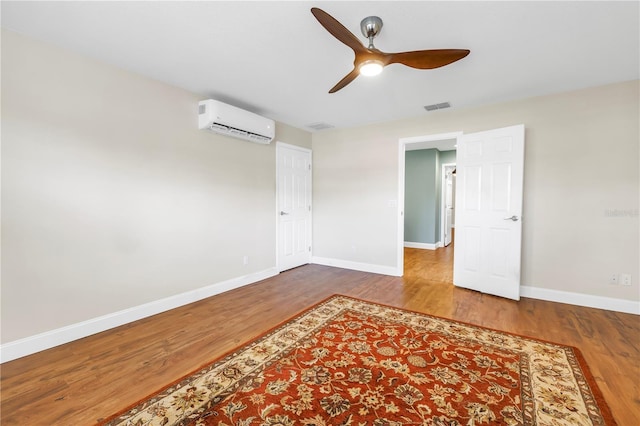13785 Oak Forest Blvd S, Seminole, FL 33776 - spare room featuring ceiling fan, visible vents, baseboards, wood finished floors, and a wall mounted AC