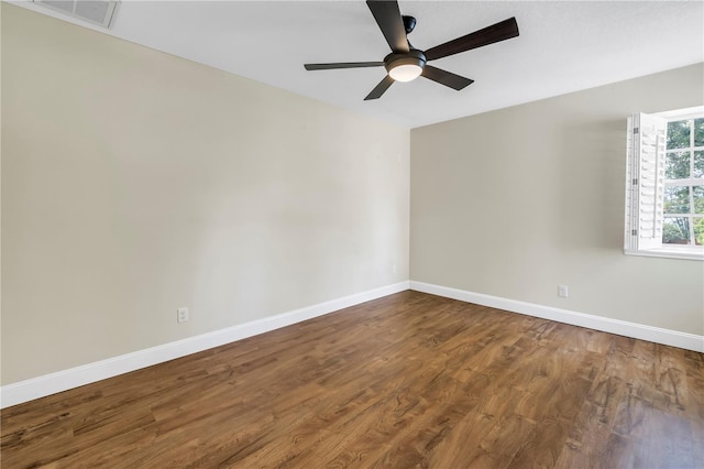 13785 Oak Forest Blvd S, Seminole, FL 33776 - unfurnished room with baseboards, a ceiling fan, wood finished floors, and visible vents