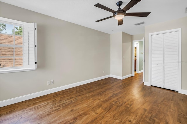 13785 Oak Forest Blvd S, Seminole, FL 33776 - unfurnished bedroom with baseboards, visible vents, wood finished floors, and a closet