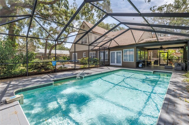 13785 Oak Forest Blvd S, Seminole, FL 33776 - outdoor pool featuring a lanai, a patio, a ceiling fan, and french doors