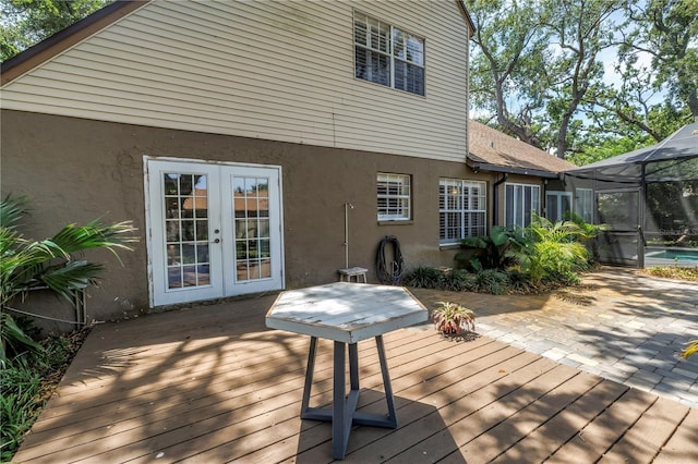 13785 Oak Forest Blvd S, Seminole, FL 33776 - wooden deck with french doors, glass enclosure, an outdoor pool, and a patio