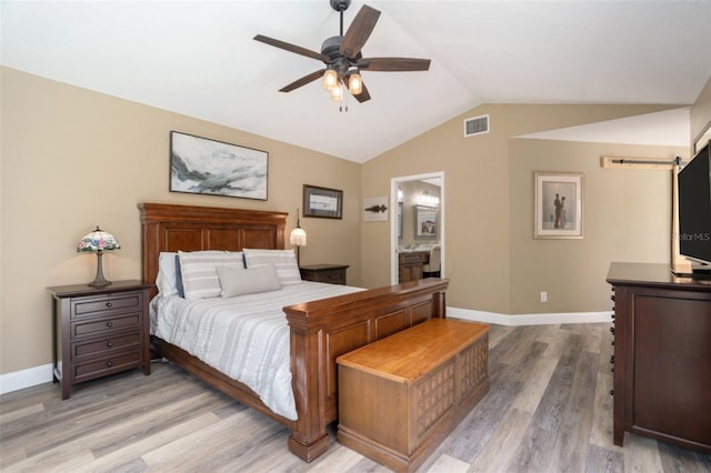 bedroom with light wood finished floors, visible vents, lofted ceiling, and baseboards