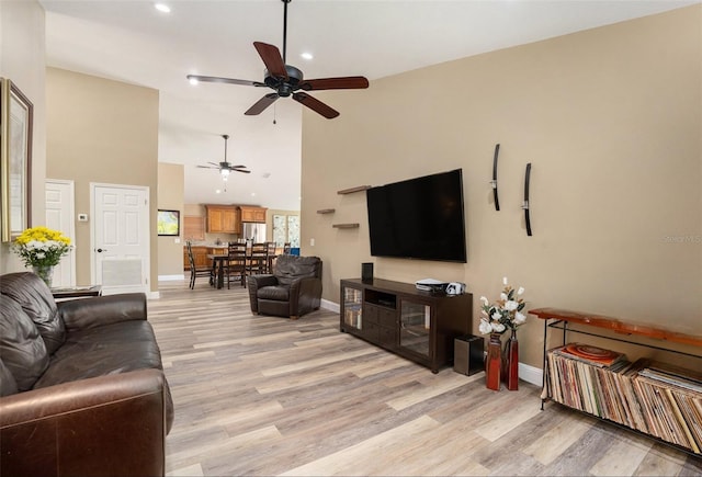 living area featuring light wood-type flooring, recessed lighting, a ceiling fan, and baseboards