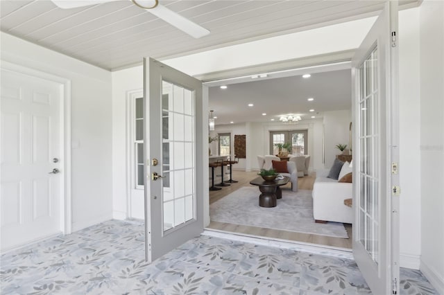 foyer with french doors, recessed lighting, and baseboards