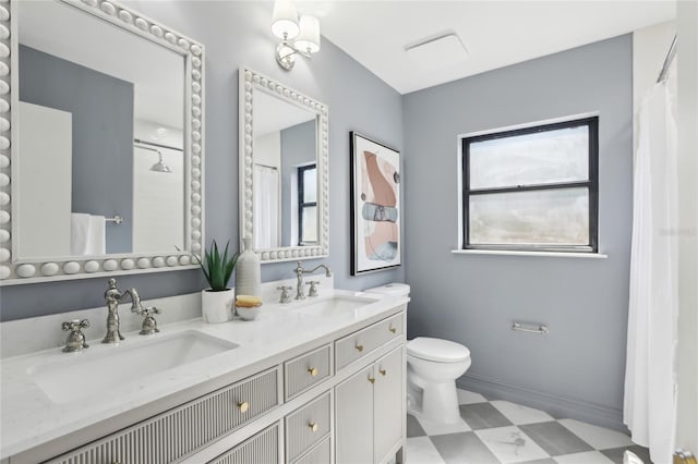full bathroom featuring tile patterned floors, toilet, double vanity, and a sink