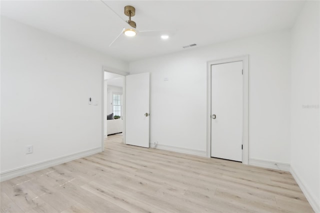 spare room featuring baseboards, visible vents, light wood-style flooring, and recessed lighting