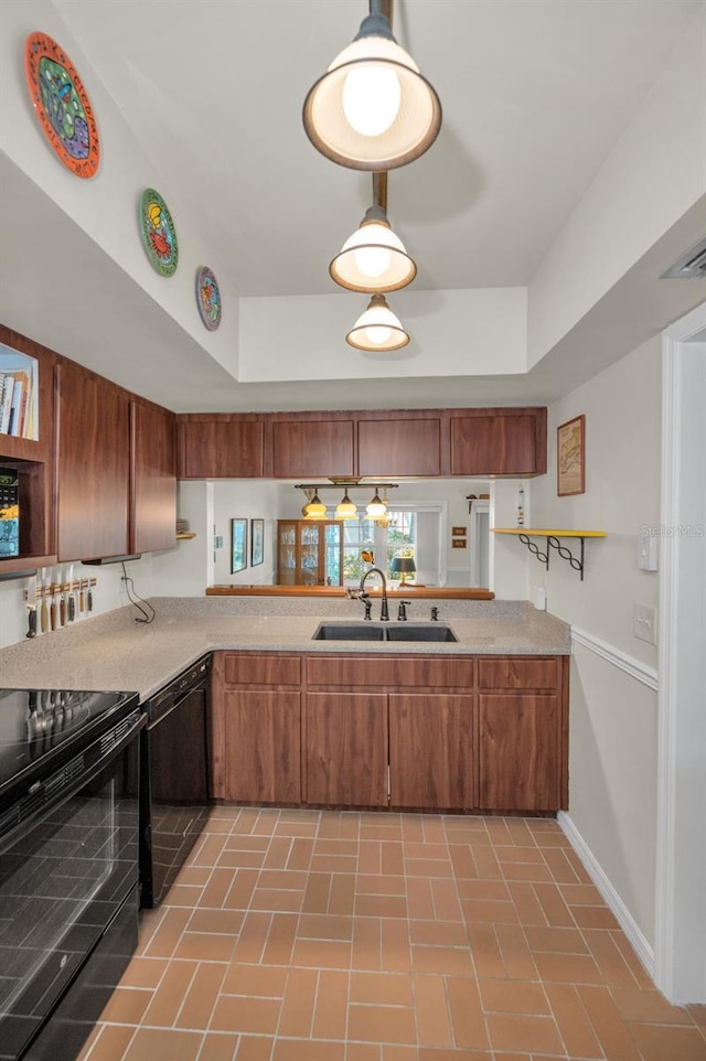 5115 S Jules Verne Ct, Tampa, FL 33611 - kitchen with brown cabinetry, light countertops, black appliances, a sink, and baseboards