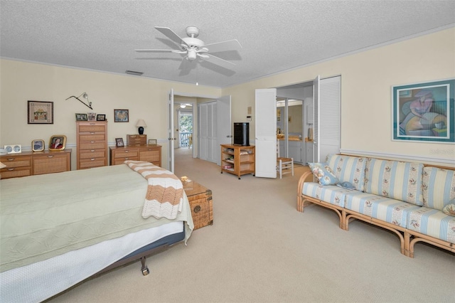 5115 S Jules Verne Ct, Tampa, FL 33611 - bedroom with connected bathroom, light carpet, visible vents, a ceiling fan, and a textured ceiling