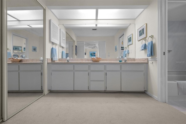 5115 S Jules Verne Ct, Tampa, FL 33611 - bathroom with double vanity, carpet, and a sink