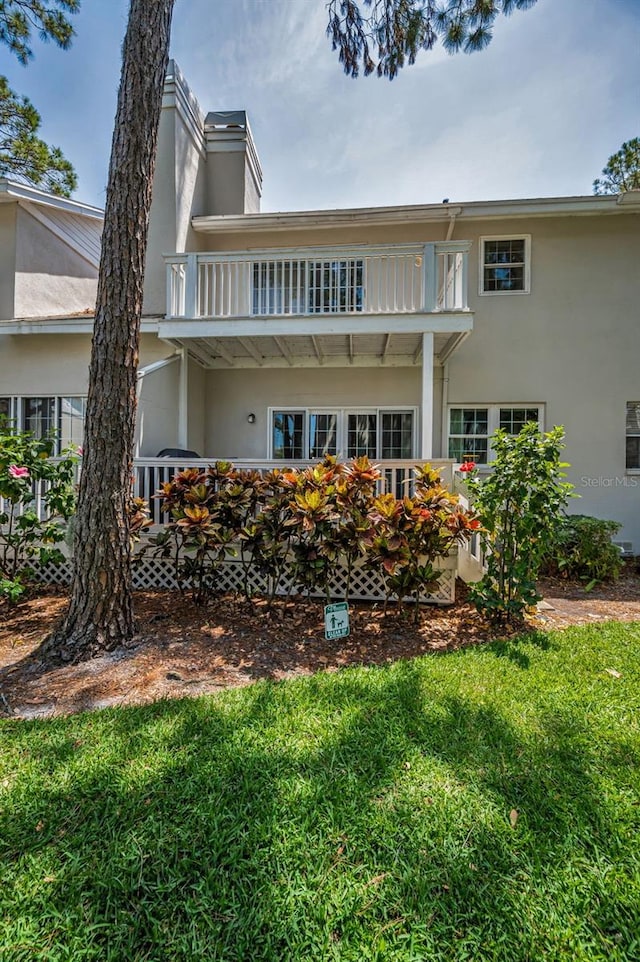 5115 S Jules Verne Ct, Tampa, FL 33611 - rear view of property with stucco siding and a balcony