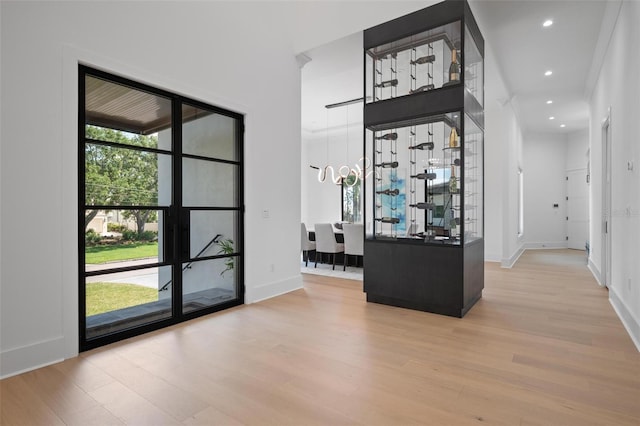 interior space with recessed lighting, wood finished floors, and baseboards