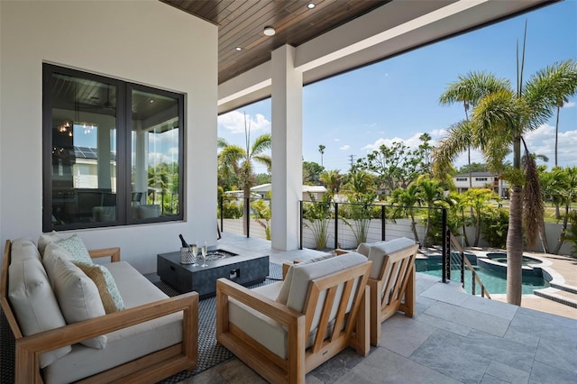 view of patio / terrace with fence, an outdoor living space with a fire pit, and a pool with connected hot tub