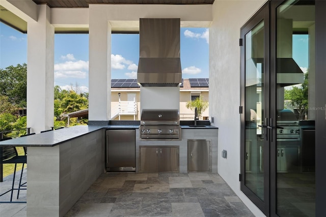 view of patio featuring an outdoor kitchen, a sink, a grill, and outdoor wet bar