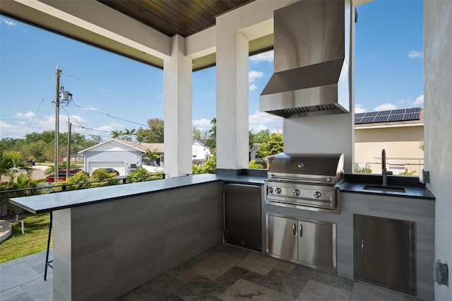 view of patio with exterior kitchen, grilling area, and a sink
