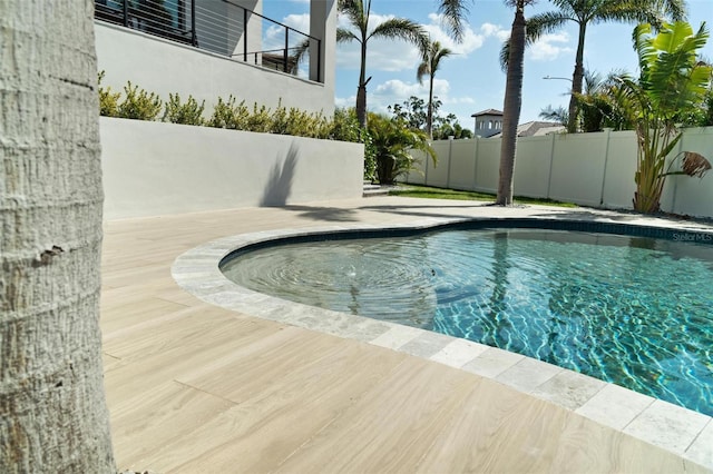 view of swimming pool with fence and a fenced in pool