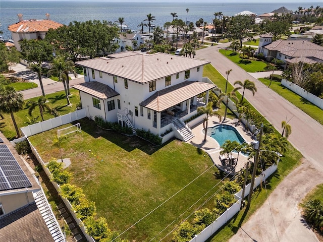 drone / aerial view with a residential view and a water view