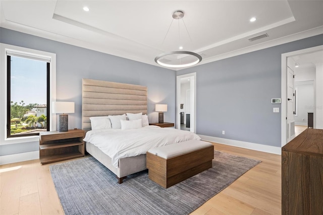 bedroom featuring wood finished floors, a tray ceiling, visible vents, and recessed lighting
