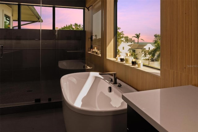bathroom with a freestanding tub and a shower stall