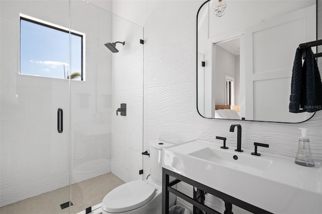 bathroom featuring toilet, vanity, and a stall shower