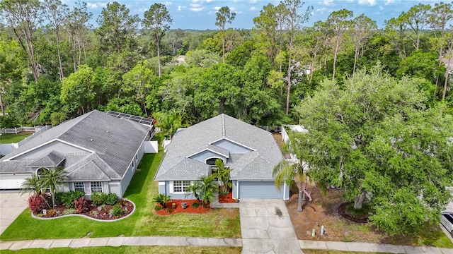 aerial view featuring a wooded view