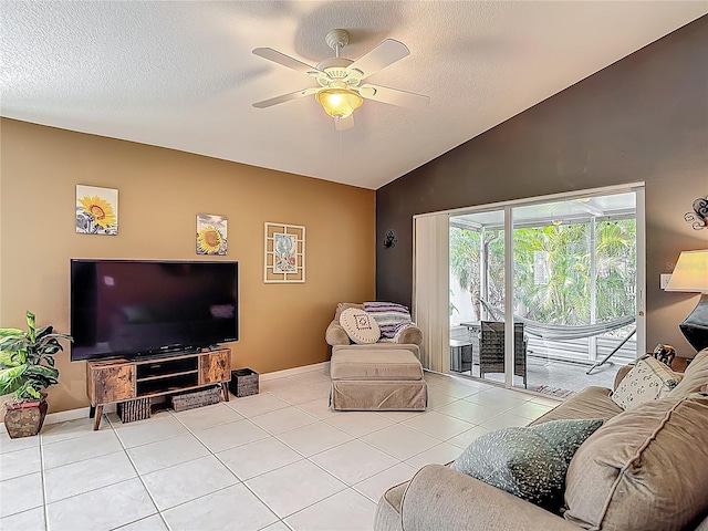 living area featuring a textured ceiling, vaulted ceiling, baseboards, ceiling fan, and light tile patterned floors